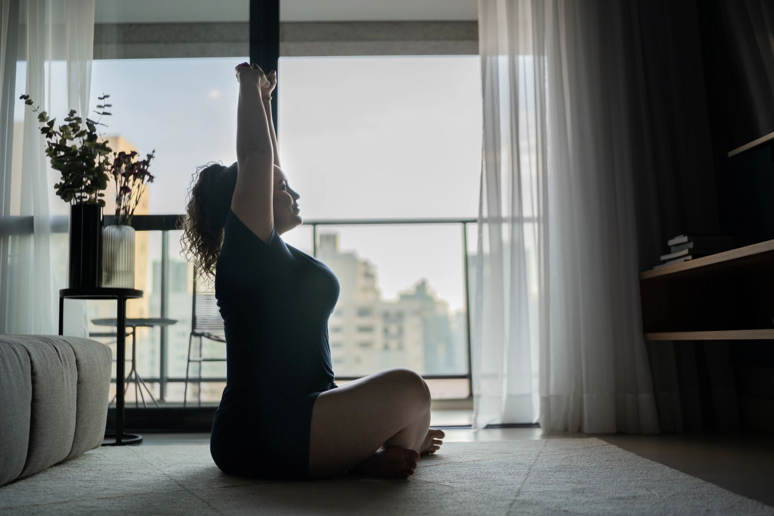 Woman stretching and exercising at home
