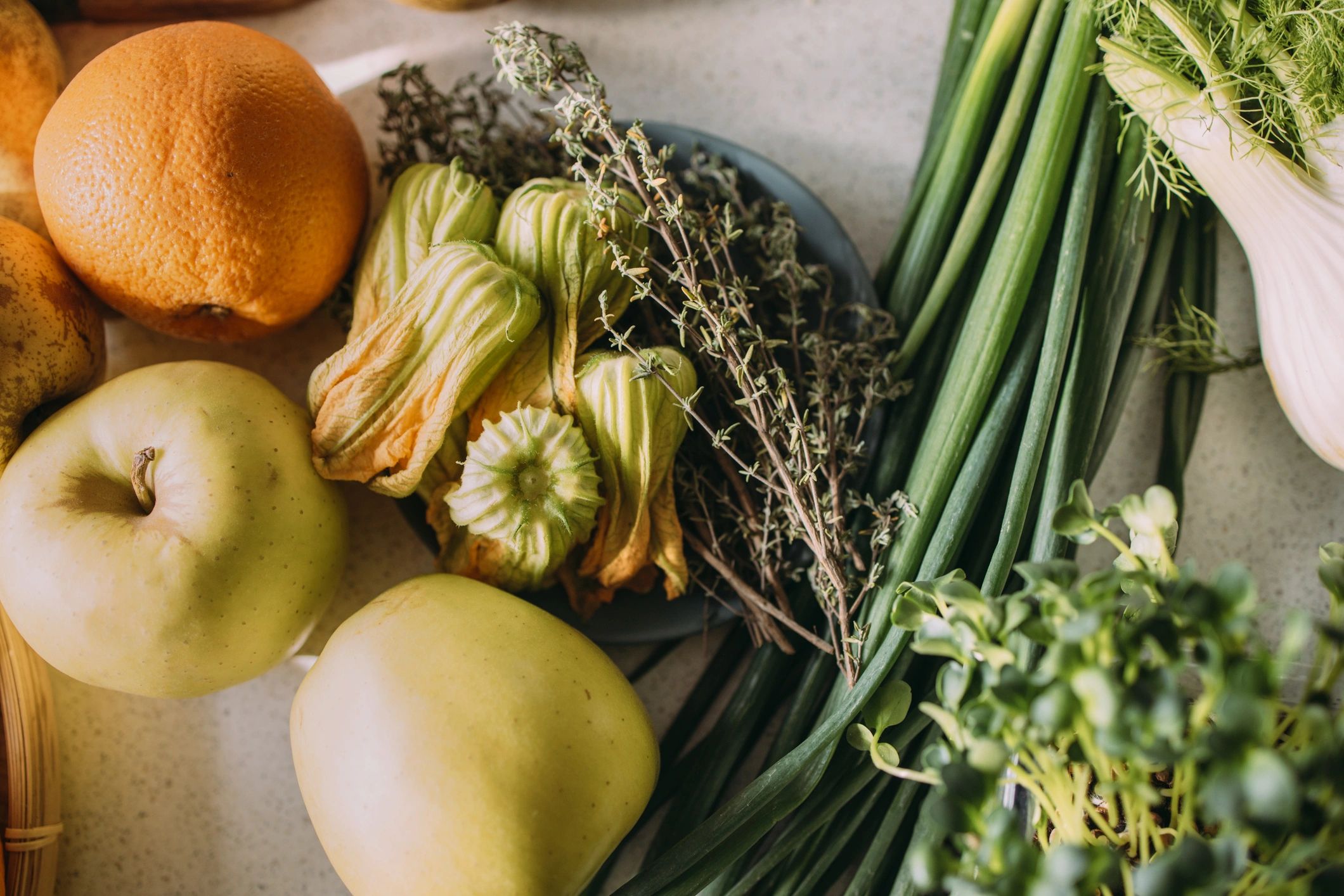 Fresh fruits and vegetables on a kitchen counter ready for meal prep