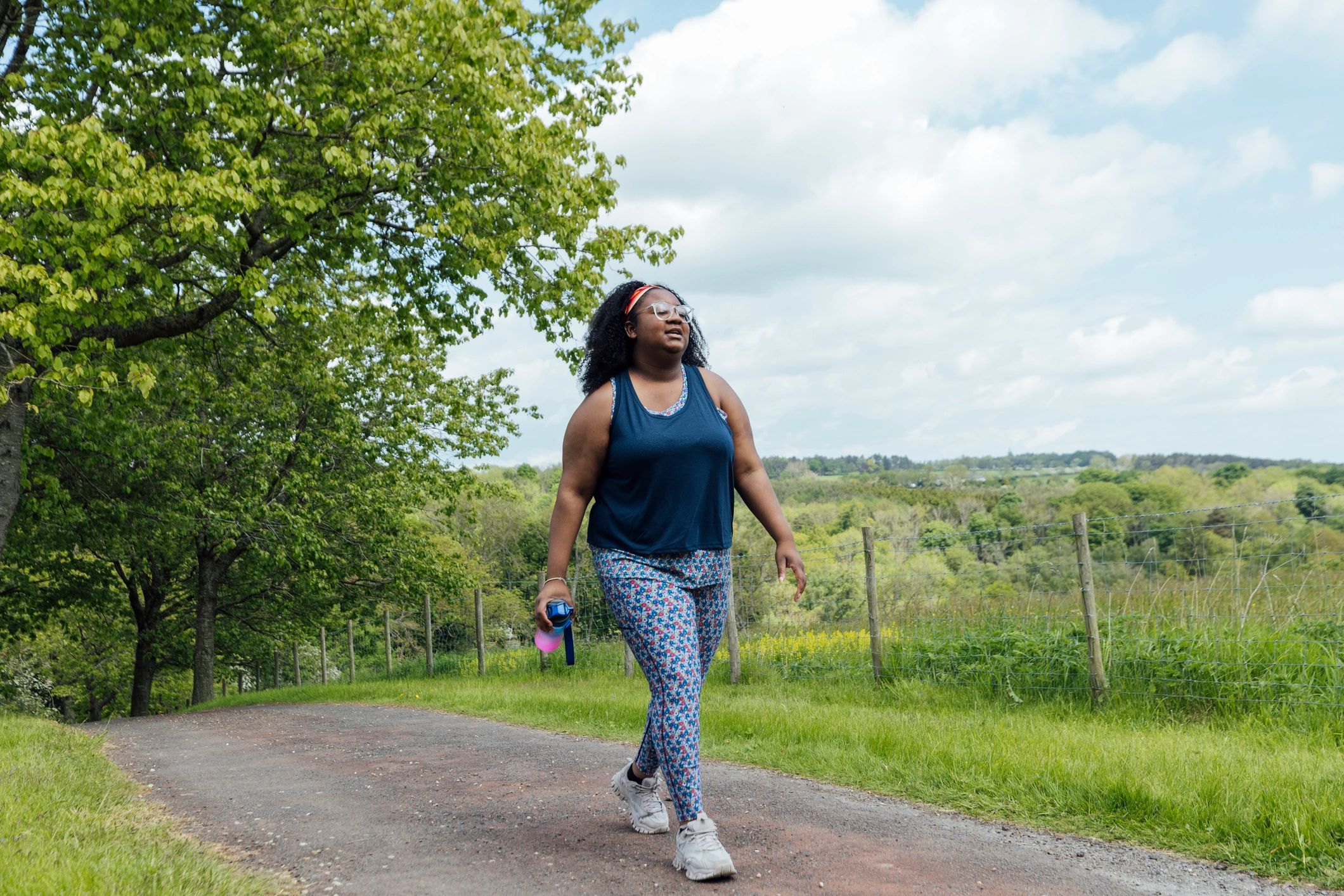 Person walking outdoors on a park trail
