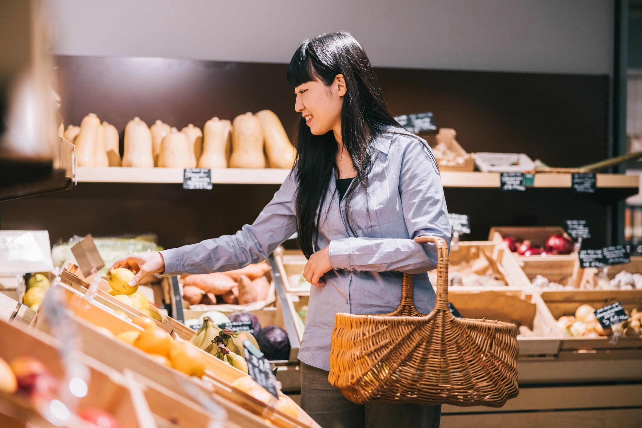 Shopper selecting fresh produce in an organic store
