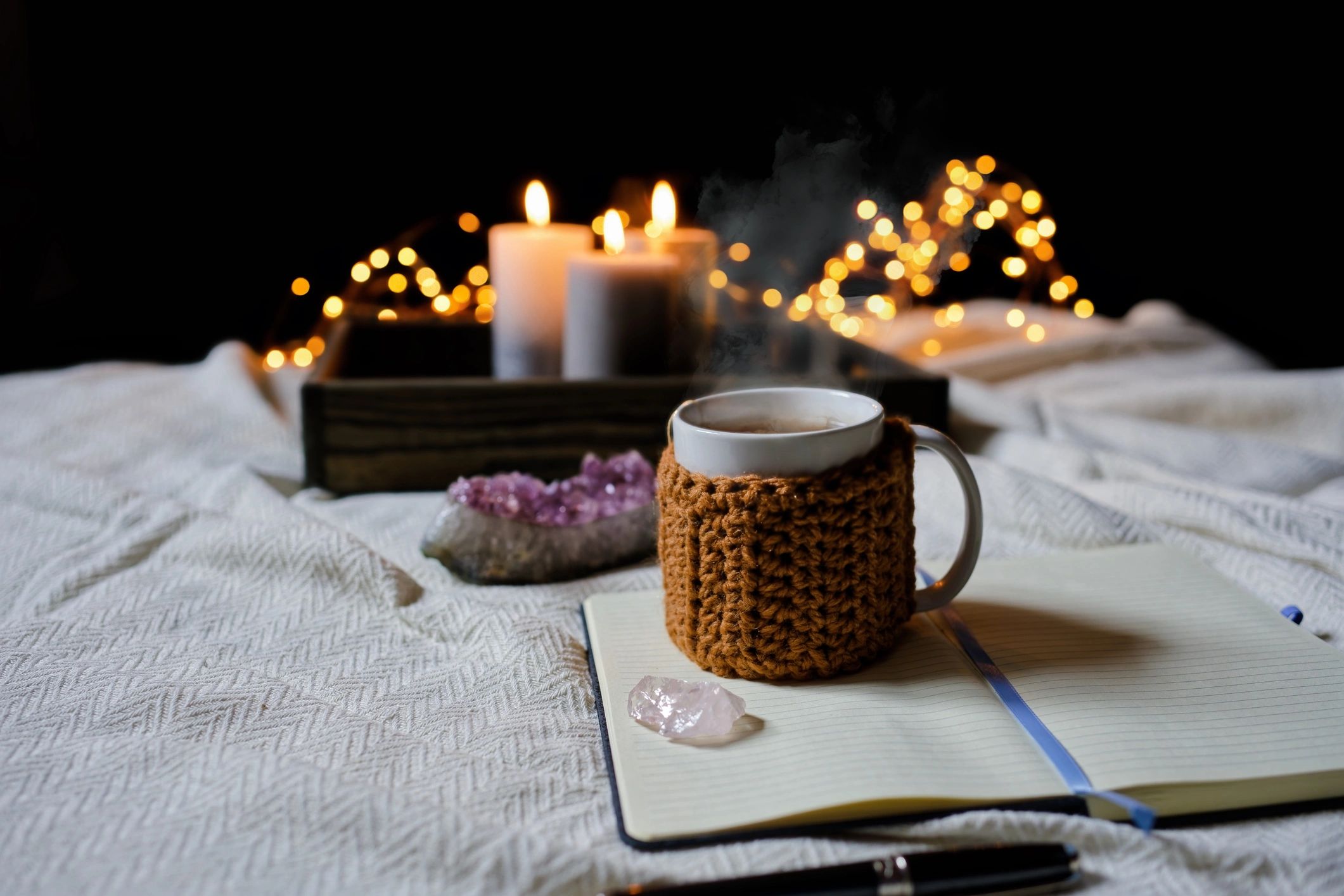 Steaming tea beside an open notebook in a calming scene