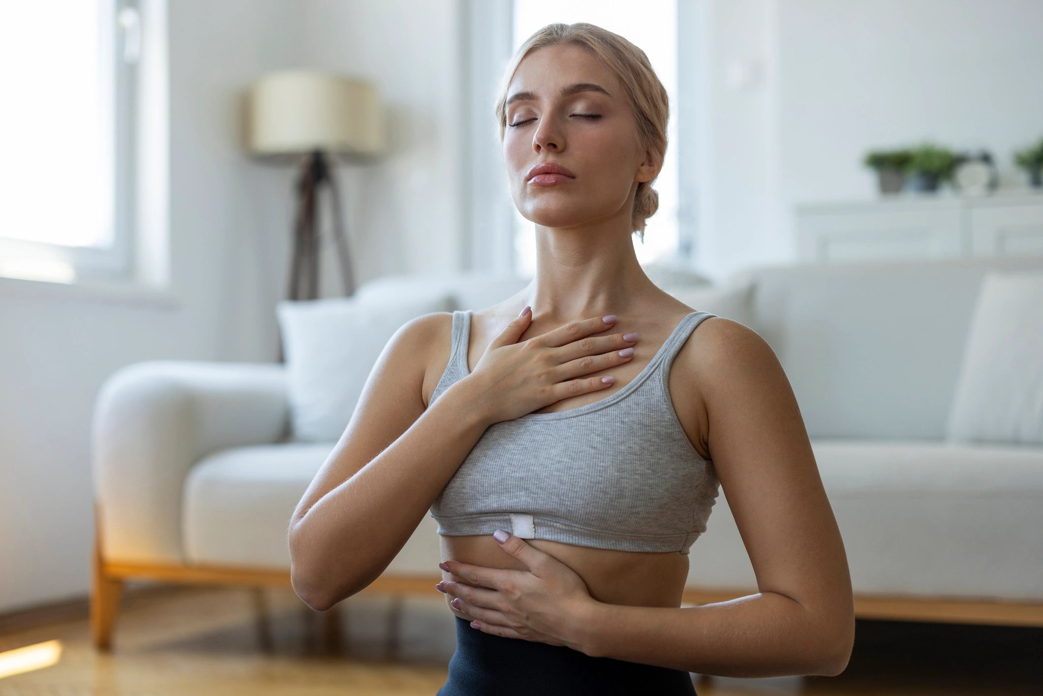 Woman practicing conscious breathing at home