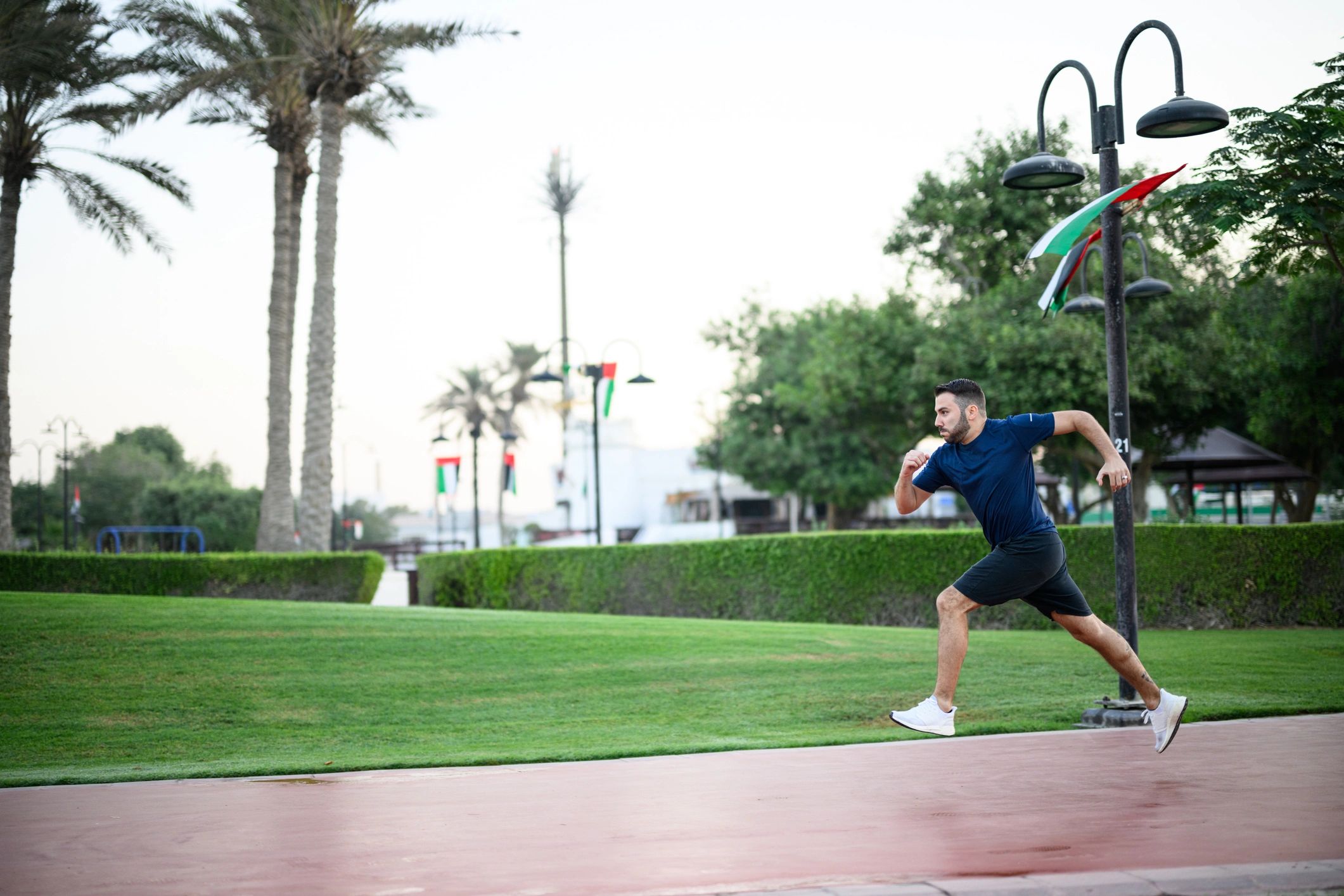 Man running in a city park at dawn