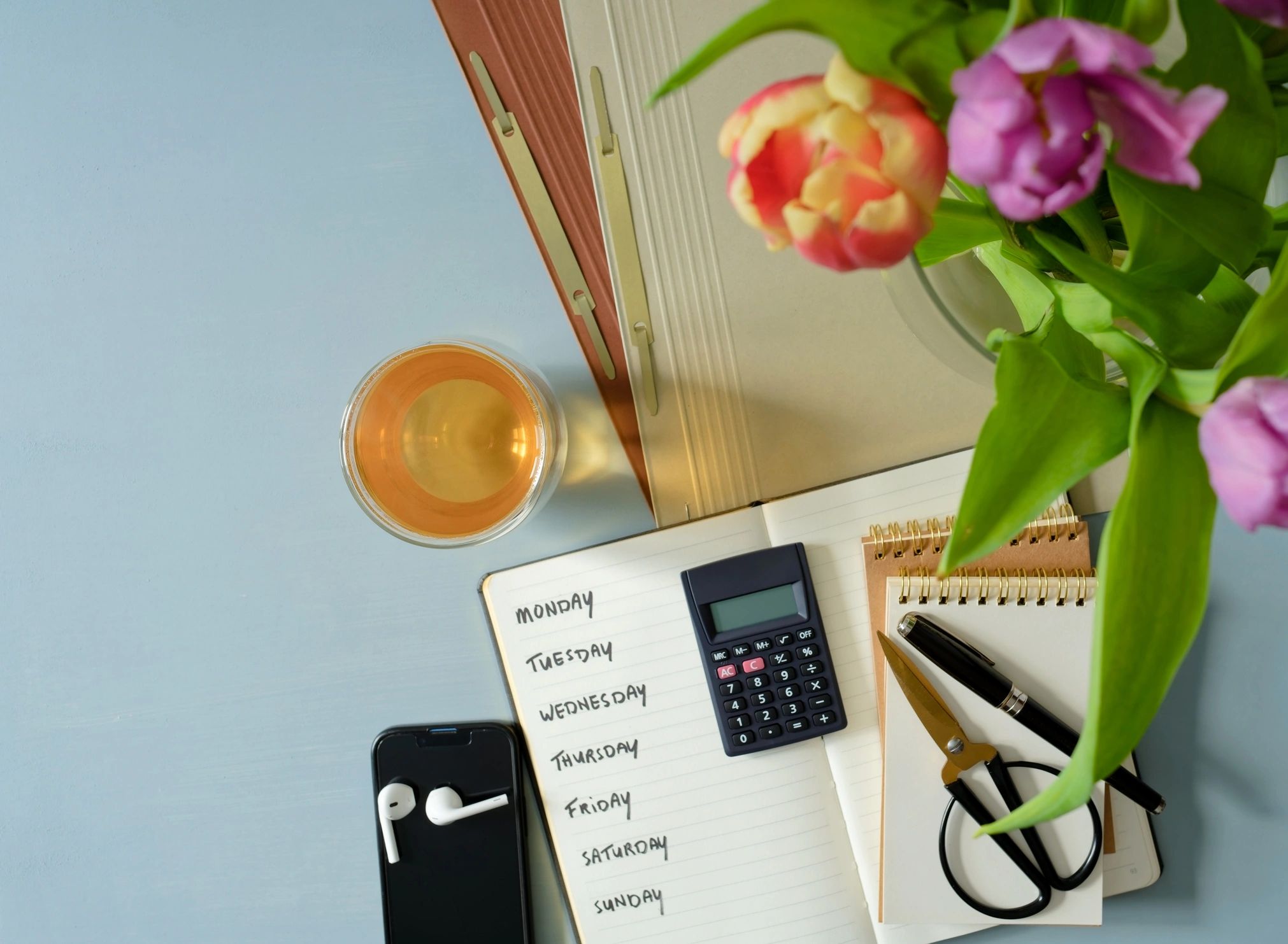 Budget planning flat lay with notebook, calculator, and smartphone